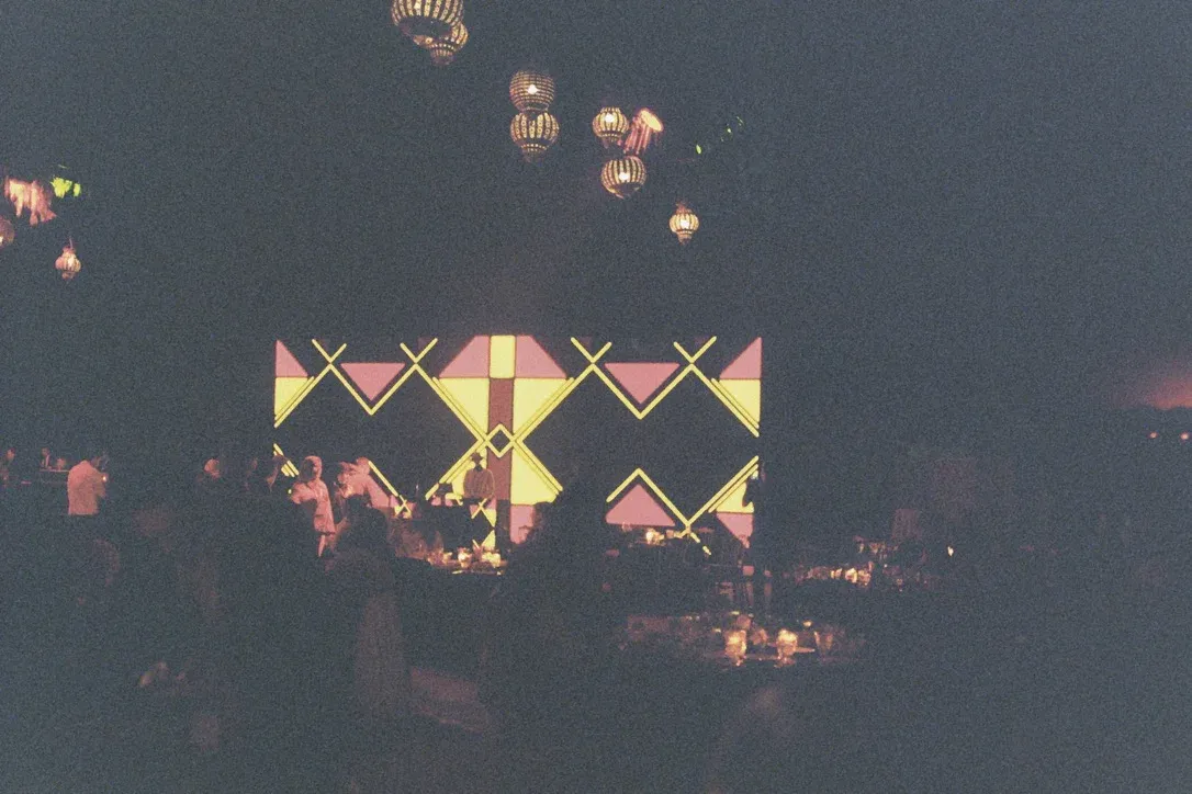 Geometric LED wall with neon lights behind the DJ at the EACL 2026 social event tent