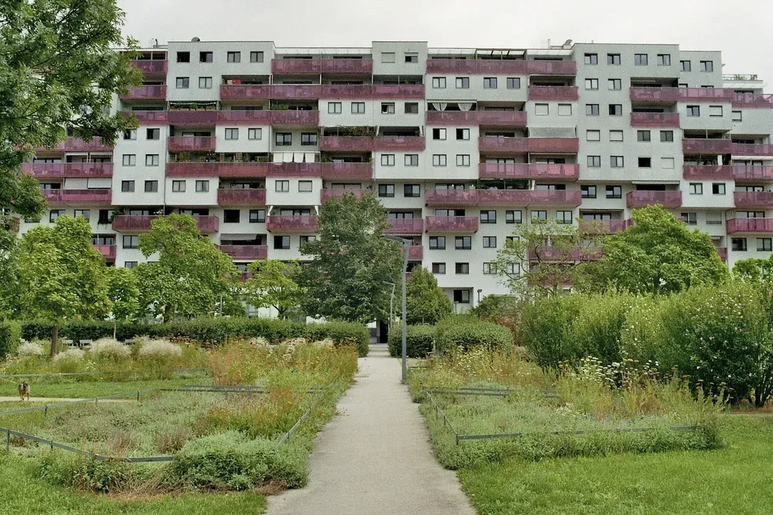 Modern high-rise buildings for communal living with tinted balconies overlooking shared gardens in Vienna